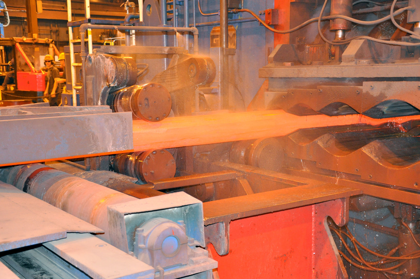 Bar being processed through the bar roller machine at Scot Forge
