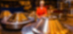 Man in hard hat sits near metal parts in a factory Scot Forge