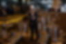 Woman wearing helmet stands among metal components in factory Scot Forge